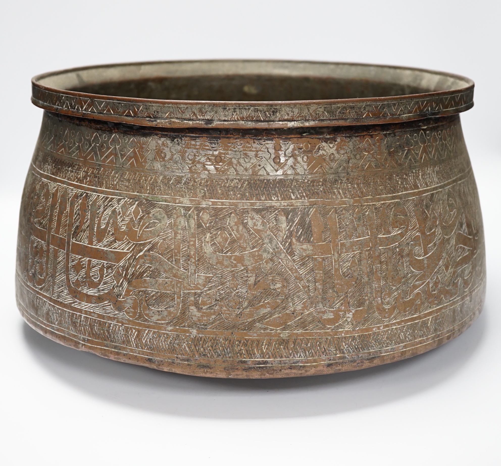 A large Islamic tinned copper bowl, inscribed in Kufic script, 38cm diameter